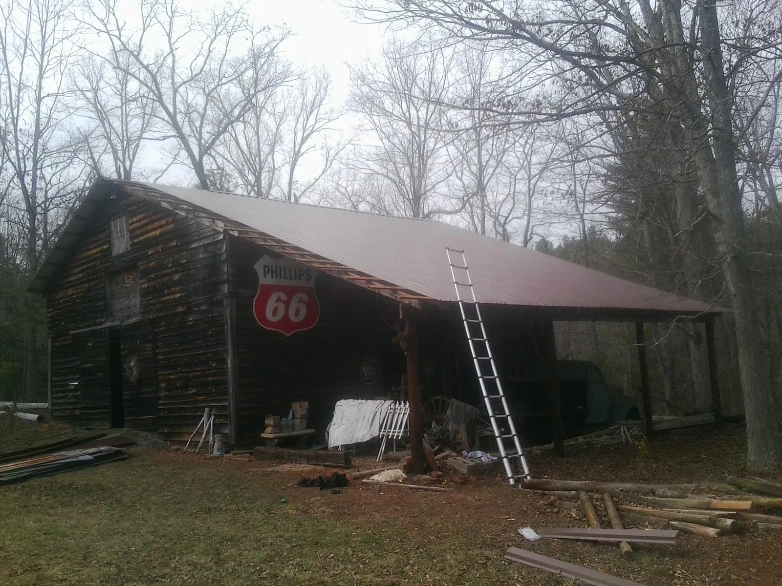 New metal roof on an open sided timber barn with a vintage sign in Douglass